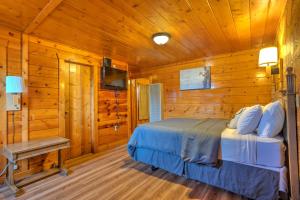a bedroom with a bed in a log cabin at Lodge at Poncha Springs in Salida