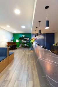 a lobby with a bar in a hospital at Daher Center Hotel in Sao Paulo