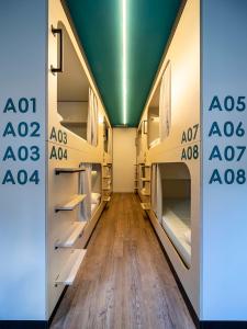 a hallway with shelving and a wall with the alo sign at Bulezen Urban Hostel in Pontevedra