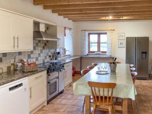 a kitchen with a table with chairs and a counter top at The Hop Pocket in Bromyard