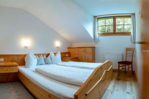 a bedroom with a large bed and a window at Ruggenthalerhof in Matrei in Osttirol