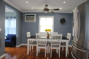 a dining room with a white table and chairs at Beautiful place minutes away to New York City . in Teaneck