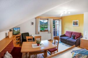 a living room with a couch and a table at Ruggenthalerhof in Matrei in Osttirol