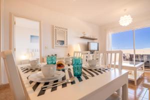 a kitchen and dining room with a table and chairs at Roque del Conde Seaview in Adeje