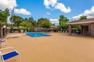 a swimming pool with chairs and a pavilion at Red Roof Inn Hardeeville in Hardeeville