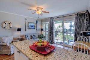 a kitchen with a bowl of fruit on a counter at Sea Cabin 131 B in Isle of Palms