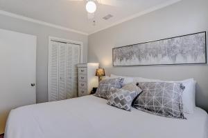 a bedroom with a white bed and two pillows at Sea Cabin 131-B in Isle of Palms