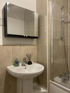 a bathroom with a sink and a shower at Relocators - Parking - Central in Birmingham