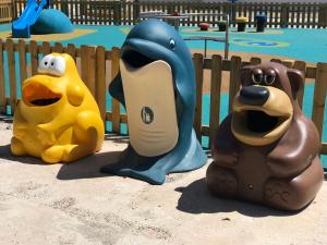 three inflatable animals in front of a pool at Cala Apartamentos in Giniginámar