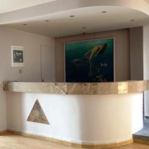 a counter in a room with a painting and a pyramid at Bristol Apartments in Kos