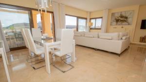 a living room with a table and a couch at Coto Real Kea 431 in Manilva