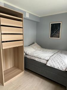 a small bedroom with a bed and a closet at Cosy 2-rooms apartment in the city center in Tromsø