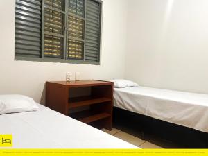 Uma cama ou camas num quarto em I9 CT - Casa de Temporada Empresarial - Agrishow