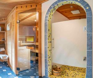 a room with a door leading into a kitchen with a tile floor at Ruggenthalerhof in Matrei in Osttirol