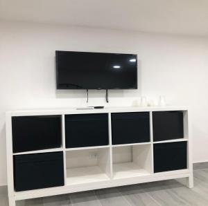 a white entertainment center with a flat screen tv on top at Casa Di Lorenzo in Naples