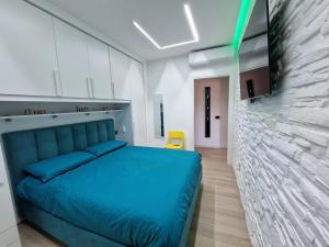 um quarto com uma cama azul e uma parede em LA CASA DI TIAGO em Palermo