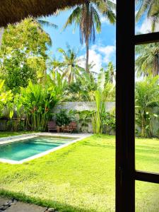 a view from the window of a villa with a swimming pool at SUNDAY Villa with private pool, near centre and beach in Kuta Lombok