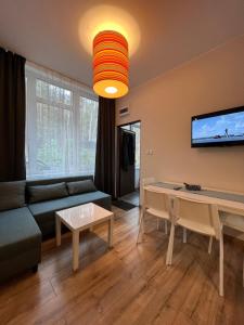 a living room with a couch and a table at Apartamenty 92 def in Ustroń