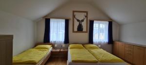 a bedroom with two beds and two windows at Ferienhaus Pepi in Strobl