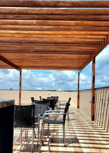 a group of chairs and tables on the beach at Paradise by Hosppedar in João Pessoa