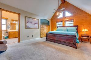 a bedroom with a large bed and a bathroom at Pet-Friendly Canyon Lake Cabin, 1 Mi to Water! in Canyon Lake