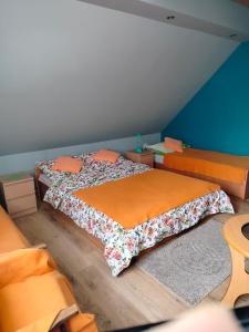 a bedroom with two beds with orange sheets at Zgorzanka in Istebna
