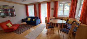 a living room with a table and chairs at Ferienhaus Pepi in Strobl