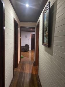 a hallway leading to a living room with a couch at Casa Vista Cafe in Cartago