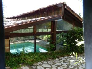 an external view of a house with a swimming pool at Residence Il Monastero in Pomarance