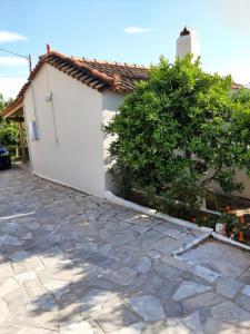 a house with a white garage and a stone driveway at Agis Apartment#4 in Nafplio