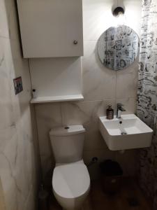 a bathroom with a white toilet and a sink at Agis Apartment#4 in Nafplio