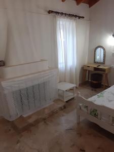 a bedroom with two beds and a mirror and a table at Agis Apartment#4 in Nafplio