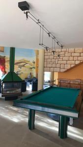 a pool table in a living room with a fireplace at Le Domaine de Charline de 1 à 35 personnes in Issel