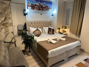 a bedroom with a large bed with two towels on it at Galapera Hotel in Istanbul