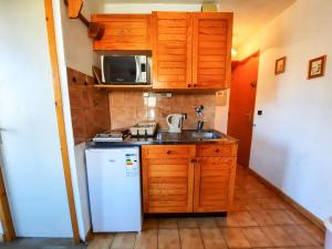 a small kitchen with a sink and a refrigerator at Studio Saint-Martin-de-Belleville-Les Menuires, 1 pièce, 2 personnes - FR-1-452-319 in Saint-Martin-de-Belleville