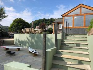 a house with a fence and a boat on the patio at Spacious 4-Bed House in Lynton in Lynton