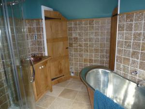 a bathroom with a tub and a sink at Spacious 4-Bed House in Lynton in Lynton