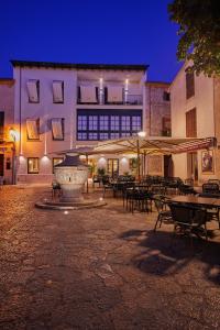 a building with a fountain in the middle of a courtyard at Mon Boutique Hotel in Pollença