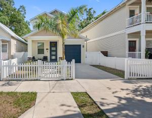 a white fence in front of a house at Cozy and spacious 4BR House with pool in TAMPA in Tampa