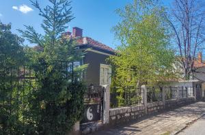 une clôture devant une maison munie d'un panneau. dans l'établissement Дионея, à Belogradchik