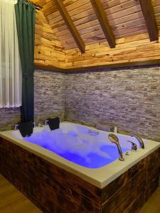 a large bath tub with blue water in a room at Zennat bungalov 