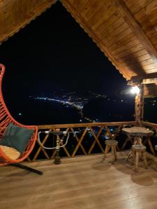 a hammock on the deck of a house at night at Zennat bungalov 