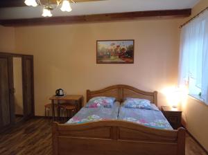 a bedroom with a bed and a painting on the wall at POLANA in Leśna