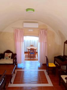 a living room with a table and a table at Loukas Kontos Traditional House in Emporio Santorini