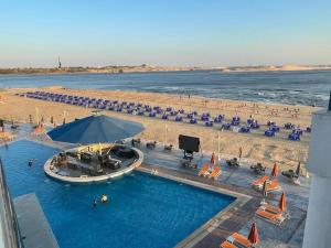 an overhead view of a swimming pool and a beach at Golden Jewel Ismailia Resort in Ismailia