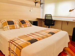 a bedroom with a bed and a desk with a chair at Family & Groups Space, Santiago Center - No Kitchen in Santiago de Compostela
