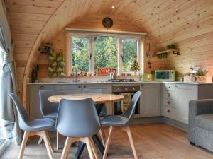 uma cozinha com uma mesa e cadeiras num camarote em Lakeview Lodge- Uk40692 em Crowhurst