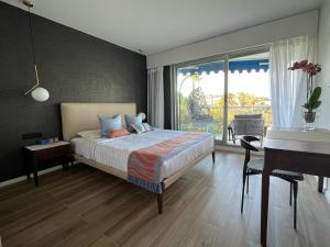 a bedroom with a bed and a desk and a desk at Parc Montfleury in Cannes