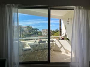 a sliding glass door with a table on a balcony at Parc Montfleury in Cannes