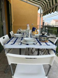 a white table with plates and dishes on it at Casa Vacanze Isabella in Campofelice di Roccella